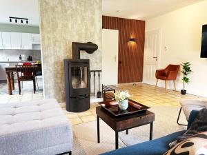 a living room with a couch and a fireplace at 92 qm - Premium Unterkunft - Wibbelt No 23 in Greven