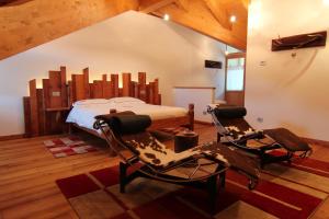 a bedroom with a bed and two chairs at Albergo Edelweiss - LareSpa in Crodo