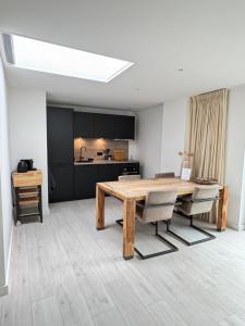 a dining room with a wooden table and chairs at Casa Nova Arnhem in Arnhem