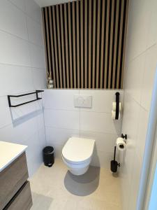 a white bathroom with a toilet and a sink at Casa Nova Arnhem in Arnhem