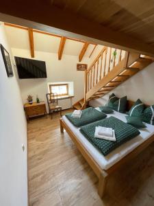 a bedroom with a bed with green pillows at Svatojakubský pivovar 