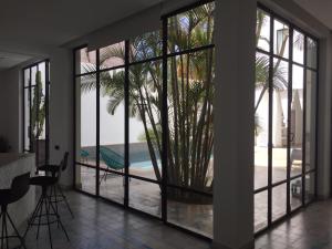 a living room with large windows and a view of the beach at Villa blanche in Mirleft