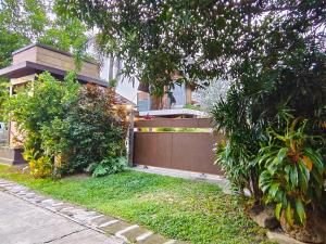 a fence in front of a house at Ingsala by CafeAtLuv22 in Ban Bo Rae +40 photos