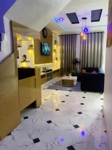 a living room with a couch and a table at Kstephen Apartment in Lekki