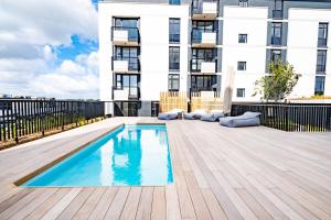 a swimming pool on a deck in front of a building at Riverlands - Lux 1 bedroom Apartment with Parking in Cape Town