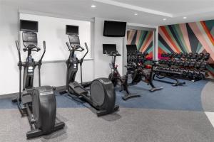 a fitness room with treadmills and exercise bikes at Hilton Garden Inn Queens JFK in Queens +21 photos
