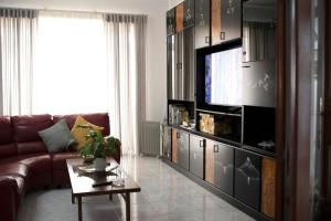 a living room with a couch and a flat screen tv at Fun for all the family! in Żebbieħ
