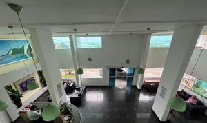 a lobby with people sitting on couches in a building at Flat Praia de PontaNegra - Natal RN in Natal