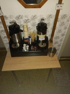 a tray with a coffee maker on a table at Hotel Restaurant zur Gondel in Bitterfeld