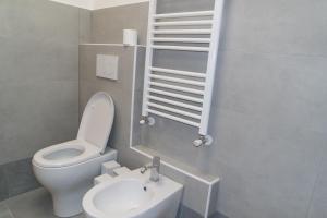 a small bathroom with a toilet and a sink at Grattacielo Rooms in Turin