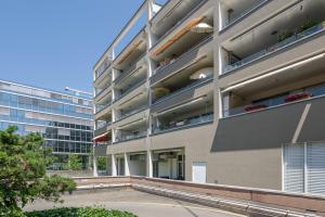 an apartment building with balconies on the side of it at City Apartment in Opfikon
