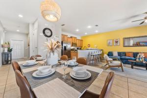 a dining room and living room with a table and chairs at 8847 Candy Palm Rd in Kissimmee