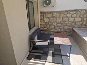 a blue chair and a table on a balcony at The Secret Tale in Varna City +5 photos