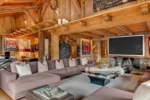 a living room filled with furniture and a flat screen tv at Megeve Luxury Estate The Royal Alpine Retreat with Mont Blanc View in Demi-Quartier