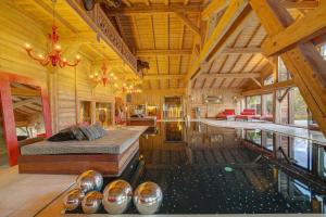 a room with a bed and a swimming pool at Megeve Luxury Estate The Royal Alpine Retreat with Mont Blanc View in Demi-Quartier +47 photos