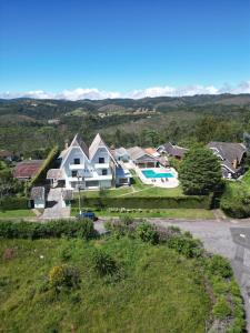a house on a hill with a swimming pool at Villa Dolce Amore - Boutique Hotel - Panorâmica in Campos do Jordão
