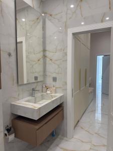 a bathroom with a large sink and a mirror at Seabreeze Polo Residence in Nardaran +29 photos