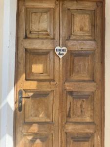 a wooden door with a sign on it at Leo home in Aosta