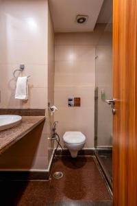 a bathroom with a toilet and a sink at Le Roi Jammu - Near Jammu Railway Station in Jammu