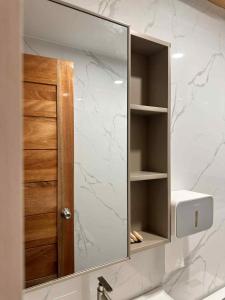a mirror over a sink in a bathroom at The Tree House - Loft Unit - Vigan in Vigan +86 photos