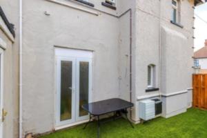 a ping pong table in the yard of a building at 2 Bed apartment, sleeps up to 5 in Blackpool