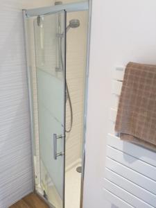 a shower with a glass door in a bathroom at Villa MA&VA in Lacanau-Océan