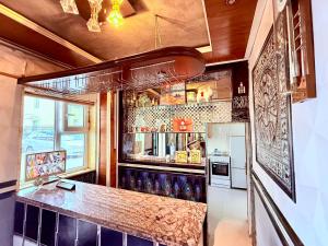 a kitchen with a bar with a counter and a refrigerator at City Hostel & Tours in Ulaanbaatar