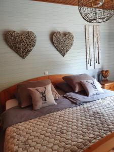 a bedroom with a bed with hearts on the wall at Eifelraum-Relaxwohnung in Oberbettingen