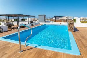 a swimming pool on the roof of a building at Beautiful condo with 4 pools and roofgarden in Mazatlán