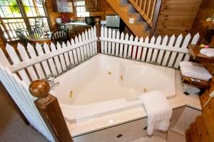 a bath tub in the middle of a house at Honey Bear Cabin in Millersburg