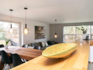 a wooden bowl sitting on a table in a living room at 6 person holiday home in Blokhus in Blokhus
