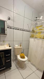 a white bathroom with a toilet and a sink at Beach house in Búzios with pool in Nísia Floresta +10 photos