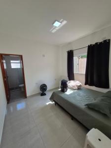 Ένα ή περισσότερα κρεβάτια σε δωμάτιο στο Casa com piscina e espaço churrasco Itanhaem