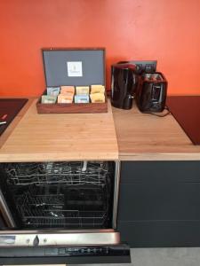a counter top with an oven with a box of food at Au Paon Dort in Cambron-Casteau