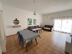 a living room with a table and a couch at Anahi Home Corralejo - Villa Cardon 12 in La Oliva