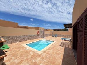a swimming pool on the patio of a house at Anahi Home Corralejo - Villa Cardon 12 in La Oliva