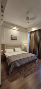 a bedroom with a large bed in a room at The Modern Haven in Greater Noida