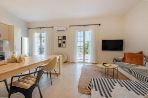 a living room with a table and a couch at Porto Blu - Sea View Apartment in Kos Town