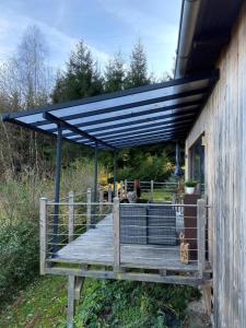 awning over a deck on the side of a house at Herzhütte Für Zwei in Vichtenstein