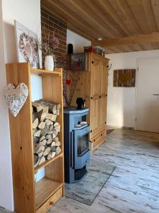 a kitchen with a wood stove in a room at Herzhütte Für Zwei in Vichtenstein +17 photos