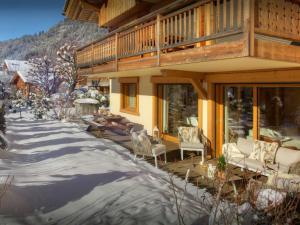 a porch of a house with snow on the ground at Chalet Edenalpa - OVO Network in La Clusaz