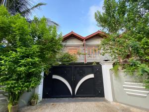 a black gate in front of a house at Berty's Cottage Home Stay in Jaffna