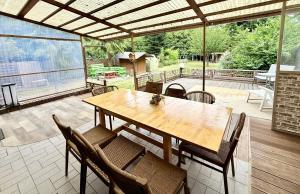 a wooden table and chairs on a patio at Cozy House in Pulheim