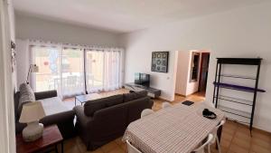 a living room with a couch and a table at Anahi Homes Corralejo - Villa Drago 12 in La Oliva