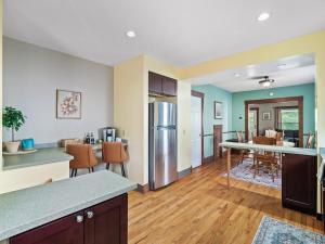 an open kitchen and living room with a table and a counter at Historic District w Fully Stocked Kitchen and Sleeps 6 in Bedford