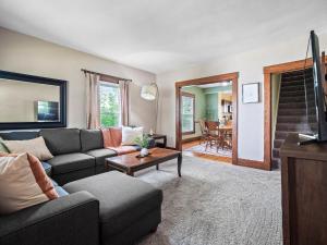 a living room with a couch and a table at Historic District w Fully Stocked Kitchen and Sleeps 6 in Bedford