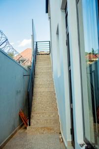 a stairway leading up to a building with a stair railing at Serene Rwanda Adventure in Kigali