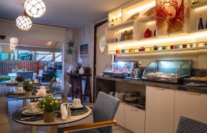 a restaurant with two tables and a fish tank at Tesouro de Noronha in Fernando de Noronha
