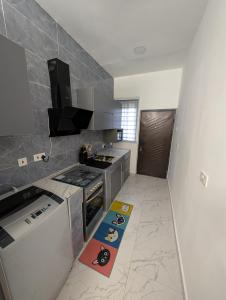 a kitchen with a stove and a counter top at Abby and Gayle Rental Apartments in Apenkwa