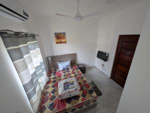 a bedroom with a bed with a quilt on it at Abby and Gayle Rental Apartments in Apenkwa